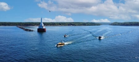 Ocean Infinityâ€™s Armada 8, flanked by Michigan Techâ€™s RV Soliton and another support vessel, travel through the Upper Entrance of the Keweenaw Waterway on their way out to begin their five-day mission in Lake Superior.