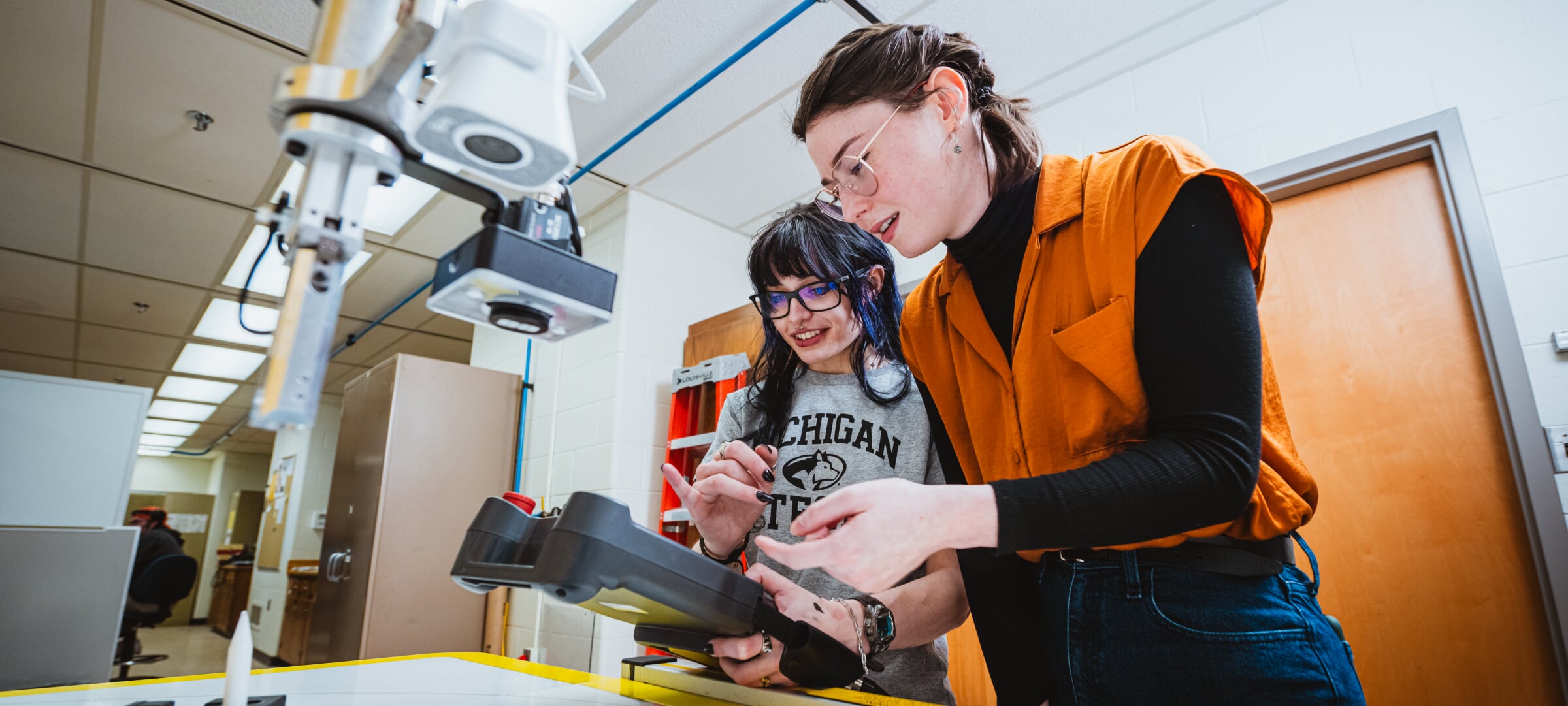 Students in a lab, working with equipment.